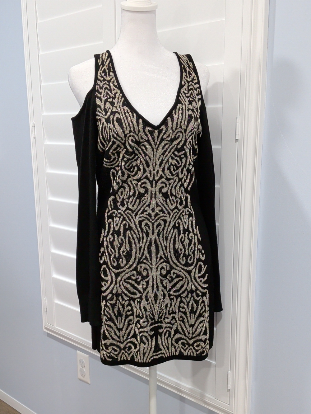 Cach'e Black V-Neck Cold-Shoulder Mini Dress With Cream And Gold Pattern.